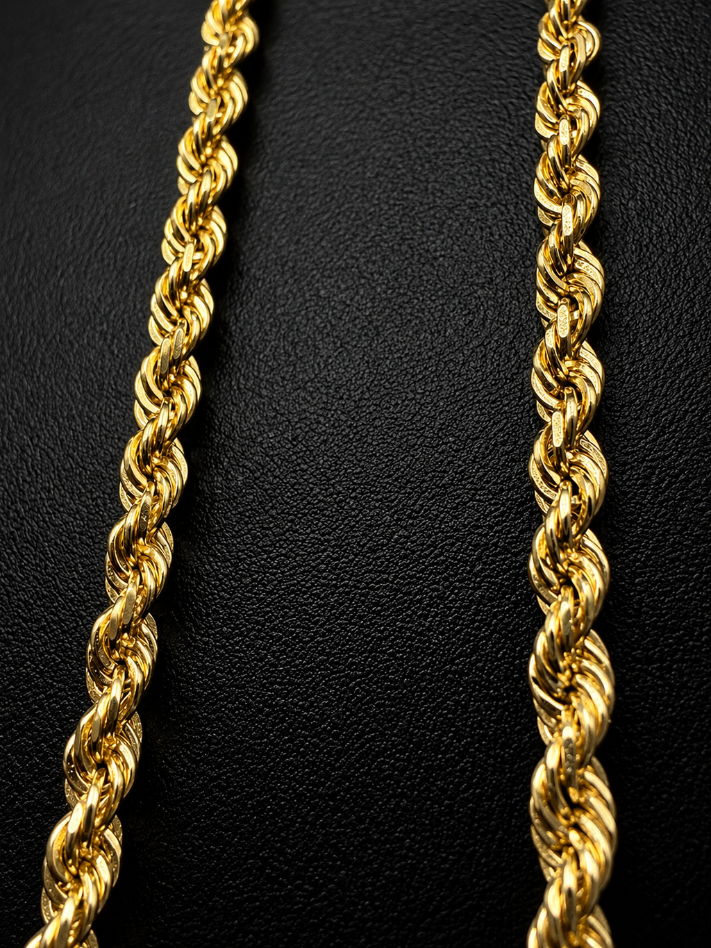 14K gold rope chain necklace held in hand showing thickness