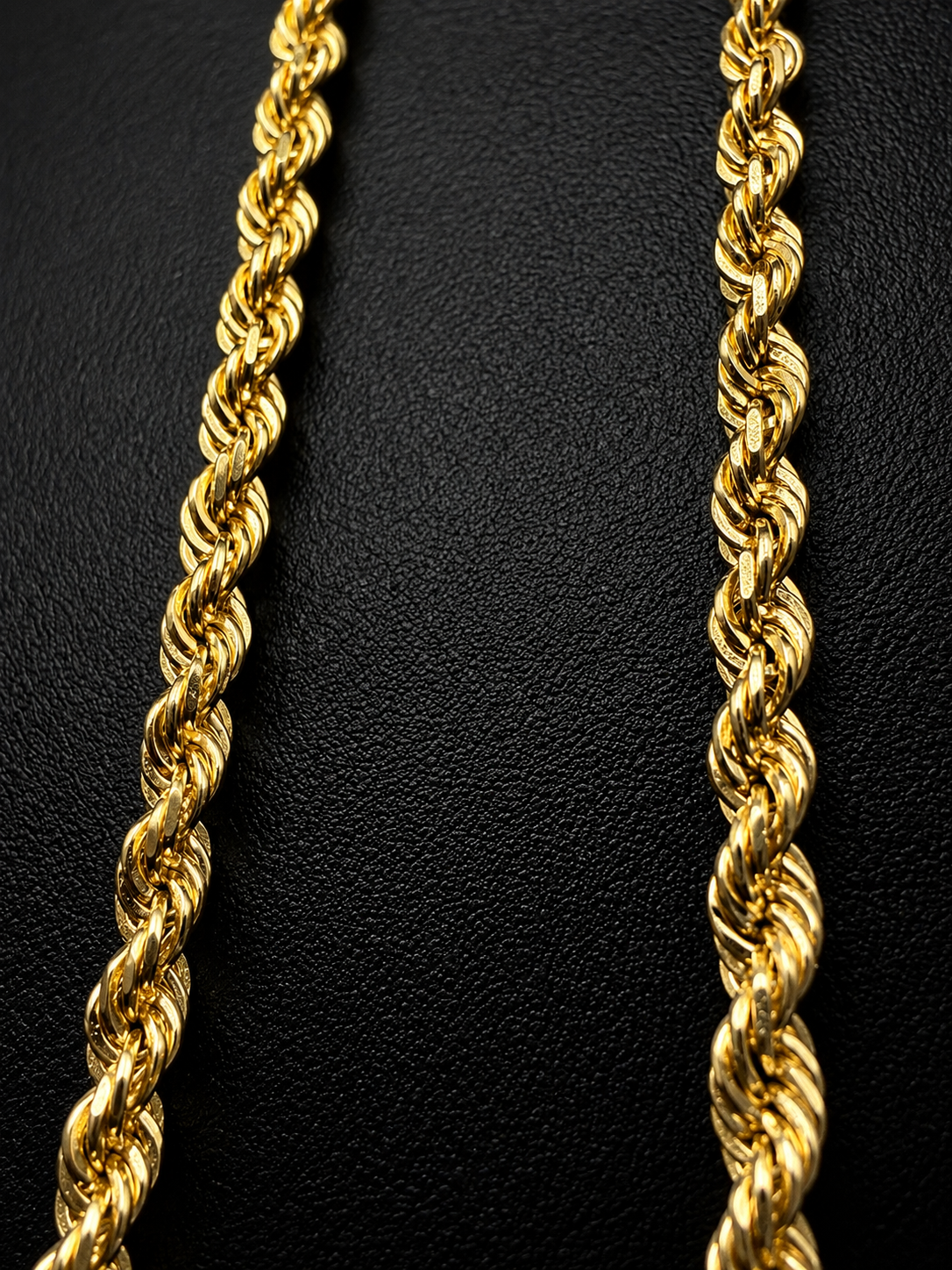 14K gold rope chain necklace held in hand showing thickness