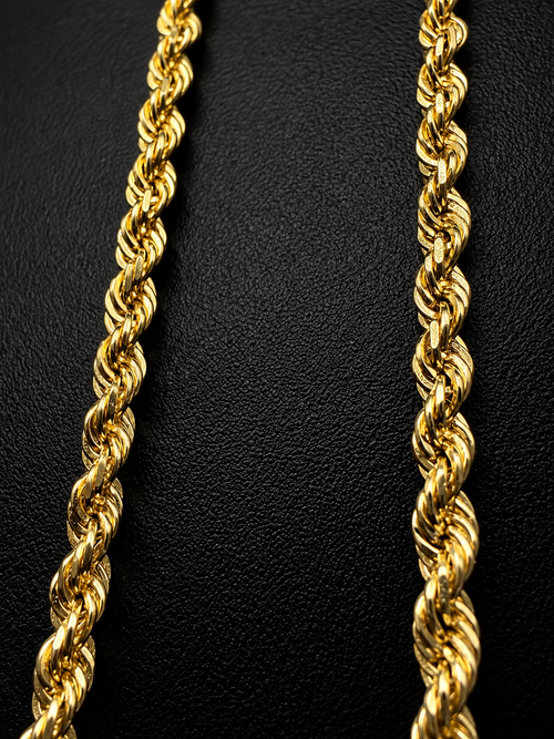 14K gold rope chain necklace held in hand showing thickness