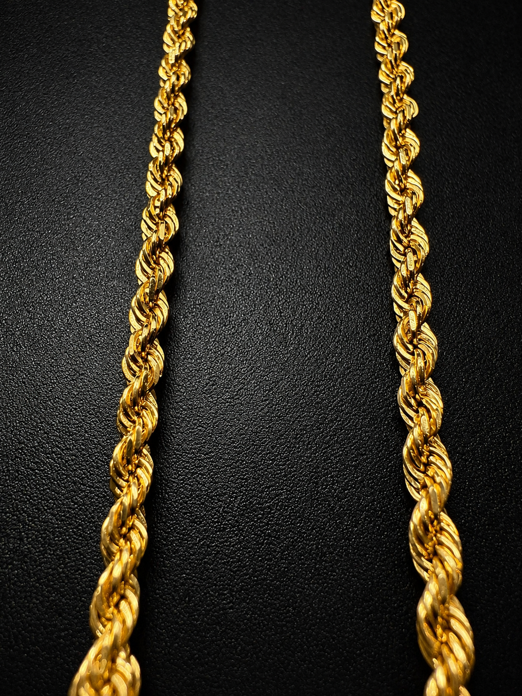 14K Italian diamond-cut rope chain necklace on black background